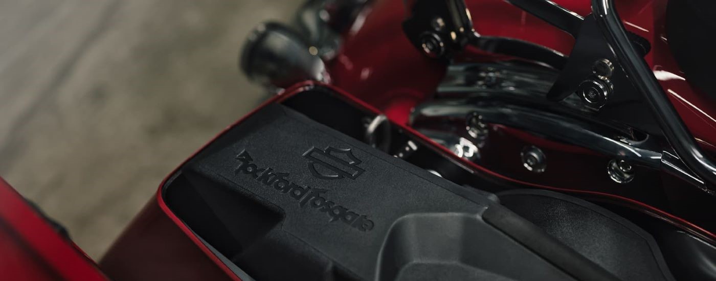 A close up shows a speaker on red 2022 Harley-Davidson Road Glide.