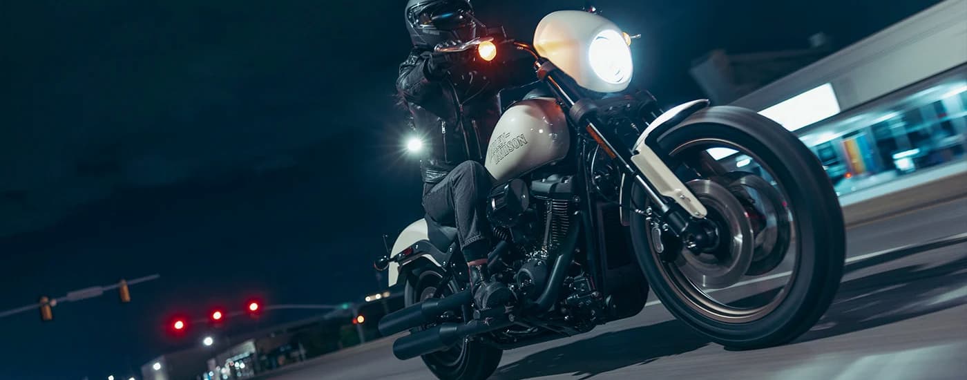 A white 2023 Harley-Davidson Low Rider S is shown on a city street at night.