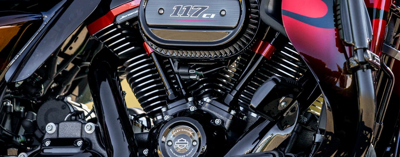 A close up of the engine on a red 2022 Harley-Davison CVO Road Glide is shown.