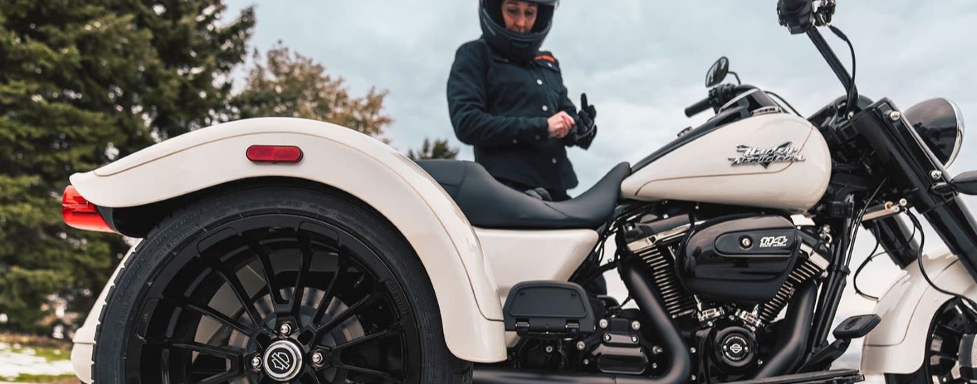 A close up shows the side of a white 2023 Harley-Davidson Freewheeler.