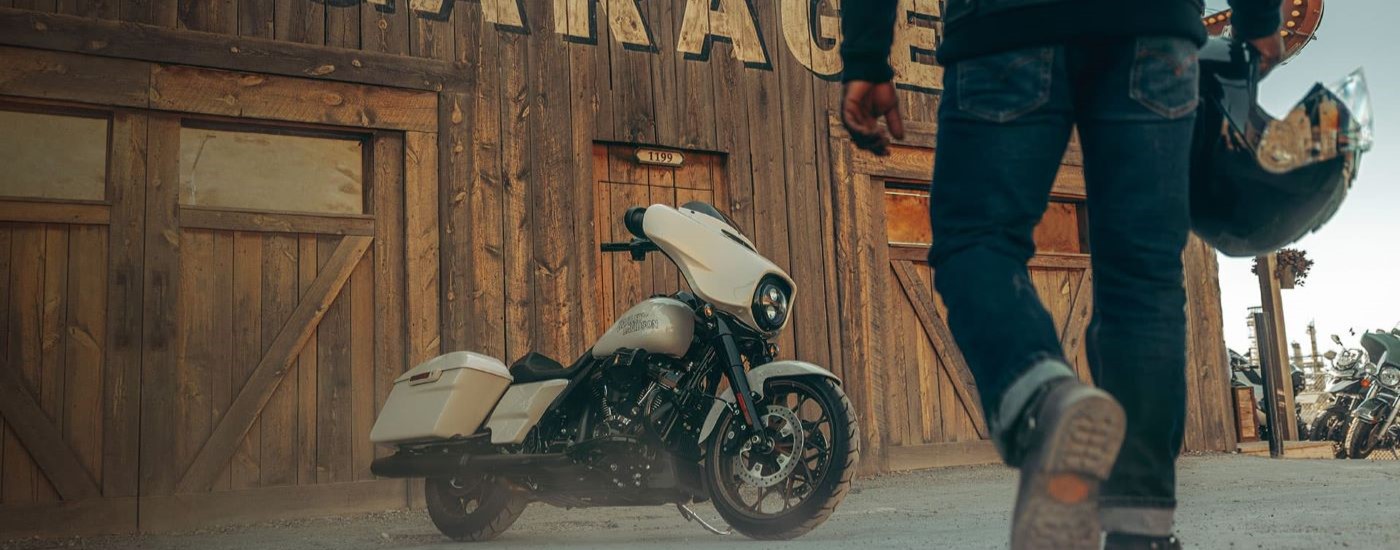 A grey 2023 Harley-Davidson Street Glide ST is shown in front of a garage after visiting a …