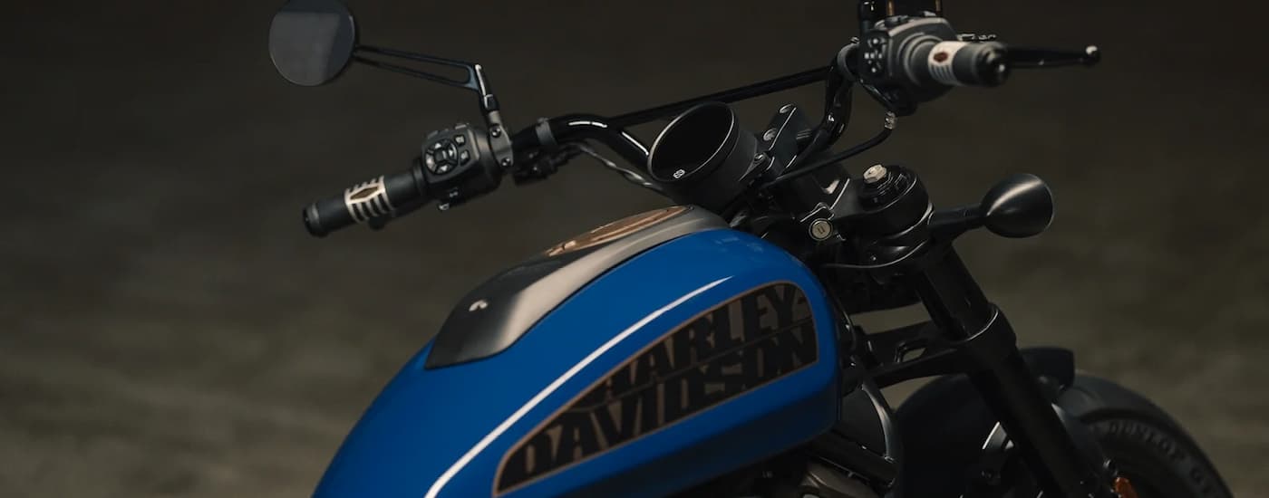 A blue 2022 Harley-Davidson Sportser S is shown parked in a garage.